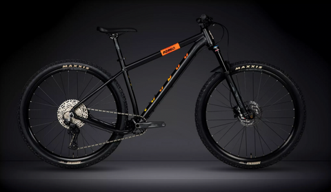 Black Voodoo Bizango mountain bike with orange stripes, leaning against a black background